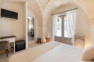 A bed or beds in a room at Masseria Villa Verde