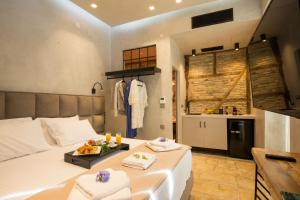 a bedroom with a bed with a tray of food on it at Libretto Suites in Lefkada