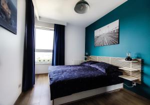 Łóżko lub łóżka w pokoju w obiekcie SUNSET HOME APARTMENTS - LIGHTHOUSE