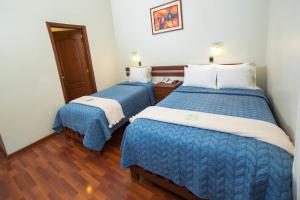 Postel nebo postele na pokoji v ubytování Antawasi Hotel