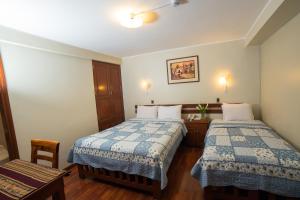 Postel nebo postele na pokoji v ubytování Antawasi Hotel