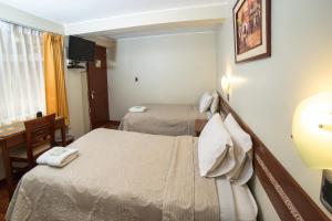 Postel nebo postele na pokoji v ubytování Antawasi Hotel