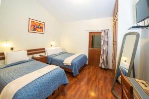 Postel nebo postele na pokoji v ubytování Antawasi Hotel