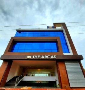 a tall building with blue windows at The Arcas Hotel in Lucknow