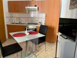 a small kitchen with a table and a stove at Jack's Place in Trbovlje