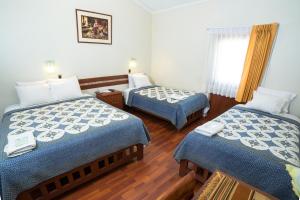 Postel nebo postele na pokoji v ubytování Antawasi Hotel