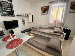 a small bedroom with a bed and a desk at Jack's Place in Trbovlje