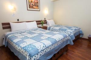 Postel nebo postele na pokoji v ubytování Antawasi Hotel