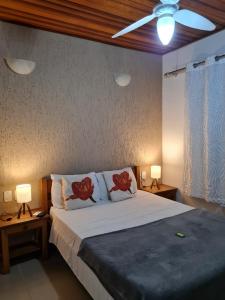 a bedroom with a large bed with two lamps at Pousada Sereia de Geriba in Búzios +107 photos
