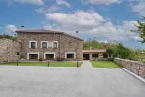 a large brick house with a driveway at La Casa De Los Pedros in Villar