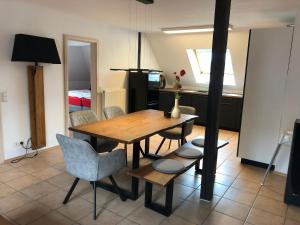 a dining room with a wooden table and chairs at Villa Lou in Mössingen