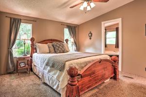 a bedroom with a bed and a ceiling fan at Waterfront Karnack Home with Boathouse and Deck! in Karnack
