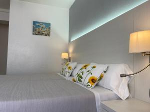 a bed room with a white bedspread and pillows at Hostal Pitiusa in Ibiza Town