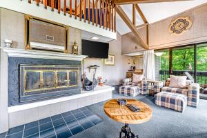 a living room with a fireplace and a table at Skiway in Beech Mountain