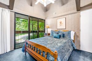 a bedroom with a bed and a large window at Skiway in Beech Mountain