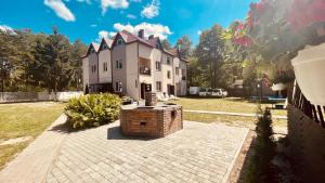 a large house with a fountain in front of it at Русалка in Szack