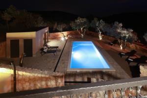 an overhead view of a swimming pool at night at Villa Pinia in Vrbnik