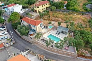an aerial view of a house with a swimming pool at Villa Pinia in Vrbnik +42 photos