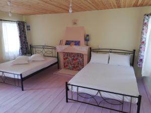 a room with two beds in a room at North Evia Kiki's house in Kourkouloí