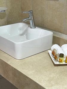 a white sink with a faucet on a counter at AZUL ARENA Hotel Boutique in Mazatlán