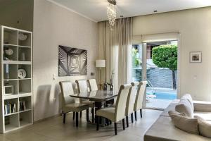 a dining room with a table and chairs at Chris Rea Villa in Skiathos