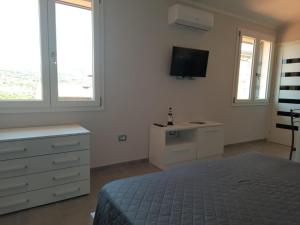 Posteľ alebo postele v izbe v ubytovaní Monolocale Arbus R0478