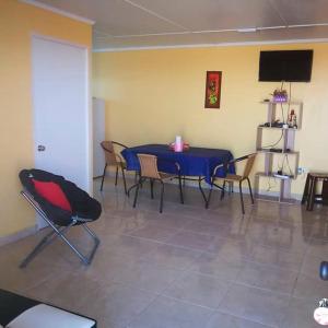 a dining room with a blue table and chairs at Cabaña Oasis de Pica in Pica