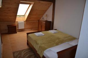 a bedroom with a bed in a room with a window at Chalet Hotel in Zhytomyr