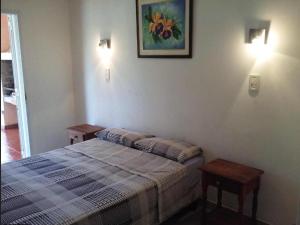 a bedroom with a bed and a picture on the wall at Complejo Familiar EL VIEJO MOLINO in Paso de la Patria +12 photos