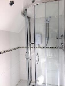 a shower with a glass door in a bathroom at BexLet in Bexhill