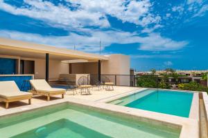 a swimming pool on the roof of a house at Sessile Tulum by The Spot Rentals in Tulum +7 photos