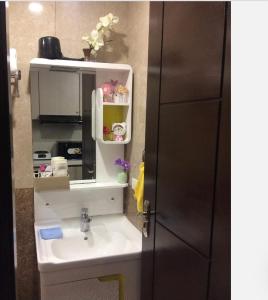 a bathroom with a sink and a mirror at COZYMINIUM in Mega 2 at the HEART of Baguio City in Baguio