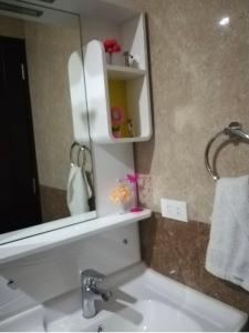 a bathroom with a sink and a mirror at COZYMINIUM in Mega 2 at the HEART of Baguio City in Baguio +17 photos