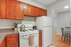 a kitchen with a white stove and a refrigerator at Spacious 2BR Apt in Lakeview near Restaurants - Oakdale 512 in Chicago