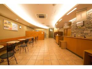 a dining room with tables and chairs in a restaurant at R&B Hotel Kanazawa Station Nishiguchi - Vacation STAY 14972v in Kanazawa +3 photos