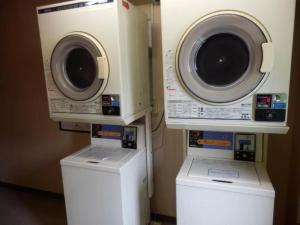 two washing machines and a dryer in a room at R&B Hotel Kanazawa Station Nishiguchi - Vacation STAY 14975v in Kanazawa +3 photos