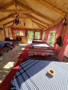 a room with several beds and a room with a rug at Gradine - Katun kamp in Plav