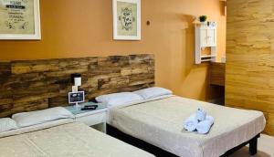 two beds in a hotel room with towels on them at DNA Cancun Hotel y Posada in Cancún +13 photos