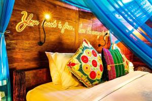 a bed with a sign that reads your taste is just not enough at Bali Bohemia Huts in Ubud