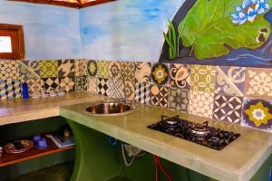 a kitchen with a sink and a counter top at Bali Bohemia Huts in Ubud