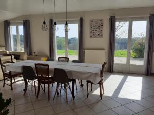 a dining room with a large white table and chairs at La maison d'Augusta in Saint-Martin-de-Coux +16 photos
