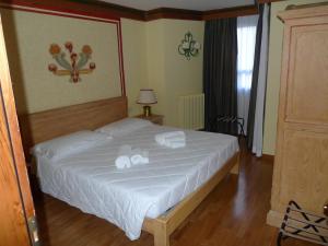 Ένα ή περισσότερα κρεβάτια σε δωμάτιο στο RTA Hotel Catturani