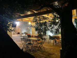 a patio with tables and chairs at night at Trullo Nadia Ostuni in Ostuni
