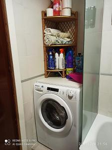 a laundry room with a washing machine in a bathroom at Apartamentos Sol y Playa Almuñecar 2 in Almuñécar