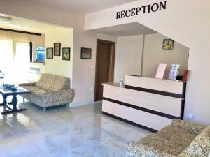 a waiting room with two chairs and a reception desk at Maria Garden in Kranevo