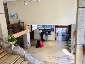 a person standing in an airport with luggage at Apartamentos Sol y Playa Almuñecar 2 in Almuñécar +16 photos