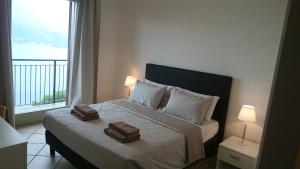 Postel nebo postele na pokoji v ubytování Lakecomoweb Apartments