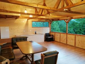 a dining room with a table in a cabin at Casa Veche Corbeni in Corbeni