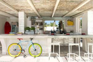 a bike parked next to a bar in a kitchen at Hotel 28 in Kamari