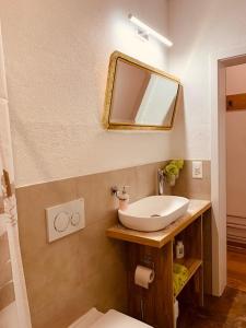 a bathroom with a sink and a mirror at Casa Restelli EG - nahe Andermatt Gotthard in Gurtnellen +36 photos